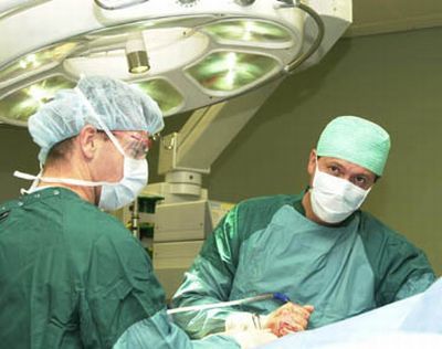 Why do surgeons always wear a blue coat when they have to operate?  And why are those operating rooms usually painted green or blue?